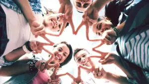 group of teenagers showing finger five gesture